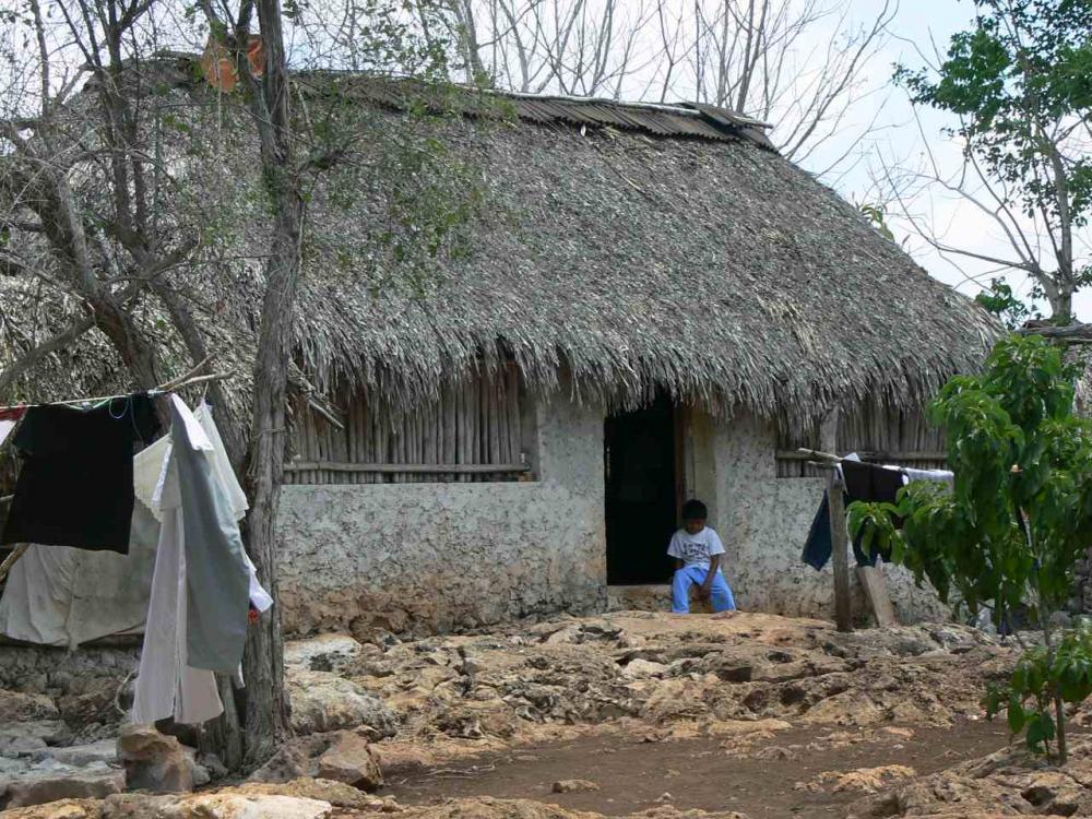 Mayan stone hut with thatched roof