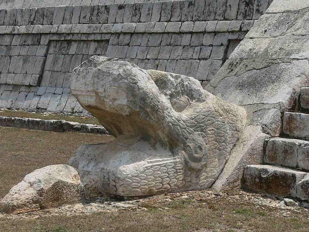 Head of the feathered serpent Kukulkan at the base of the Chichen Itza pyramid.